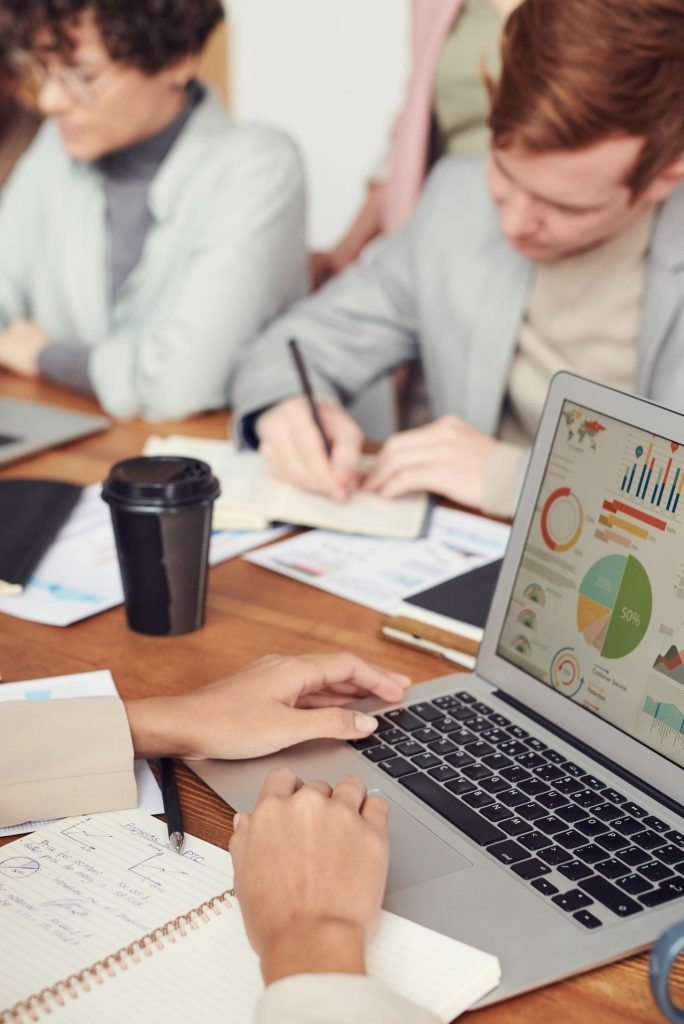 Small business team reviewing charts on a laptop while planning around Canada's AI strategy