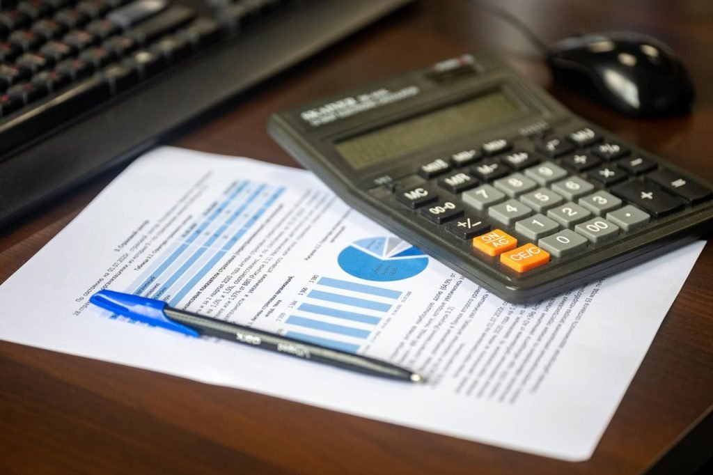 Report, calculator and pen on a desk while building an SEO plan for a small business