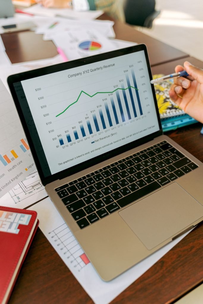 Laptop screen with analytics and revenue charts showing how AI search visibility is measured