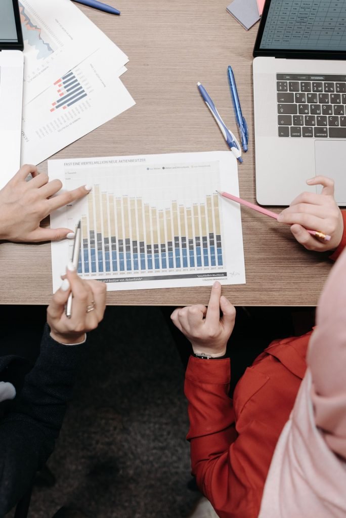 Colleagues reviewing graphs and documents to measure the ROI of a first AI agent
