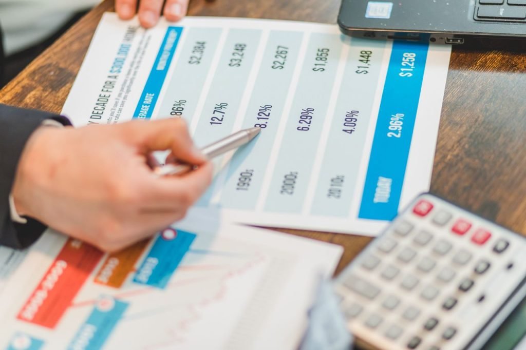 Charts, documents and a calculator used to compare website costs in Canada